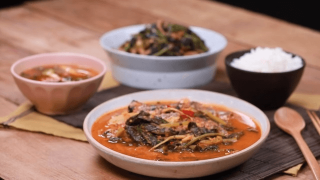 Young radish and saury stew and rice on a wooden table