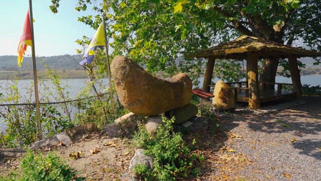 Rock tower surrounded by trees and greenery