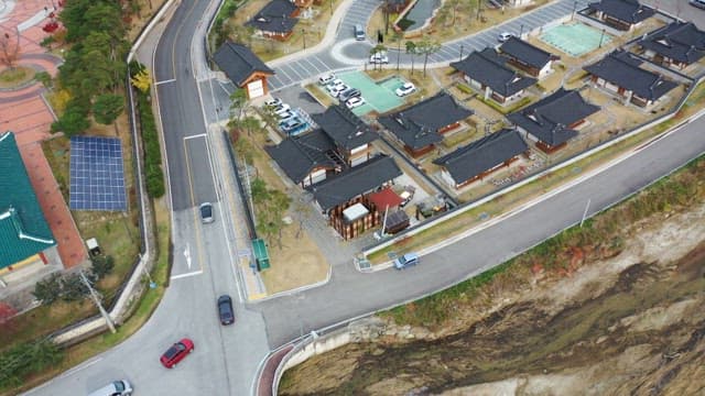 Traditional Hanok village with cars coming into the parking lot
