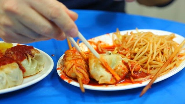 Bite of dumplings with spicy sauce