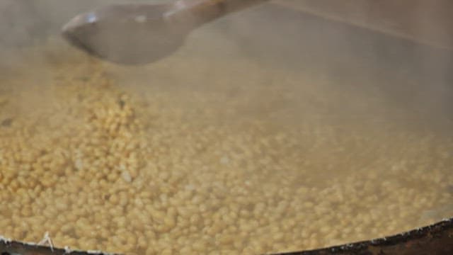 The process of boiling beans in a large pot