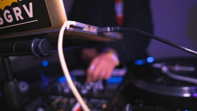 DJ performing with turntables and mixer