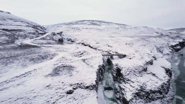 Snow-covered mountains and frozen river