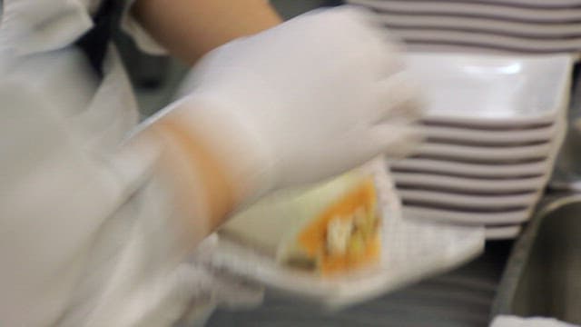 Cutting a sandwich with cream and chestnut paste with scissors