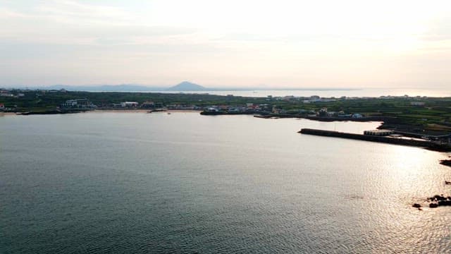 Colorful coastal town with mountains in the distance
