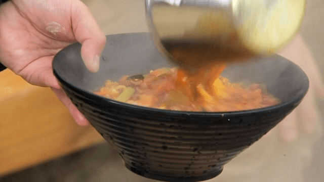 Spicy Jjamppong Ramen cooked in a large pot into a bowl
