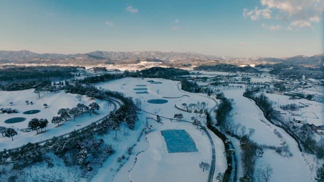 Snowy winter landscape with frozen ponds
