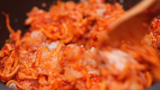 Mixing spicy sweet potato salad with rice