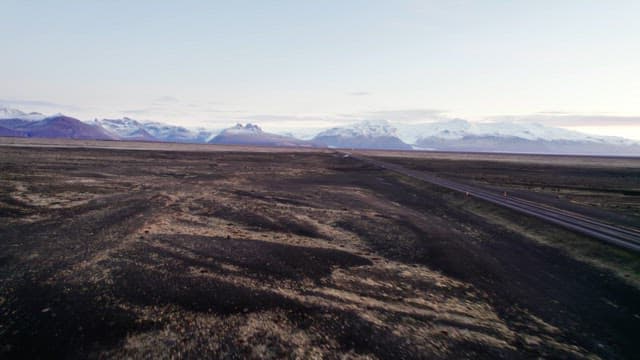 Vast landscape with distant snowy mountains