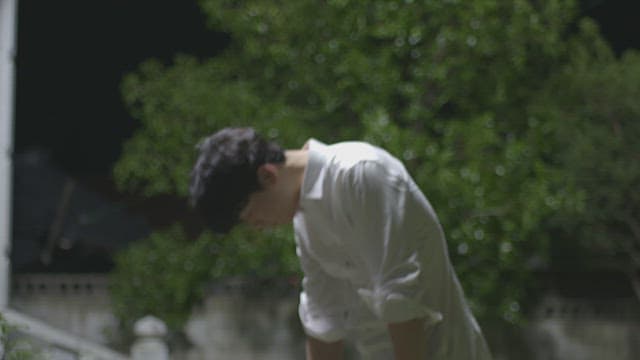 Man discovering a mysterious wooden box in his front yard at night.
