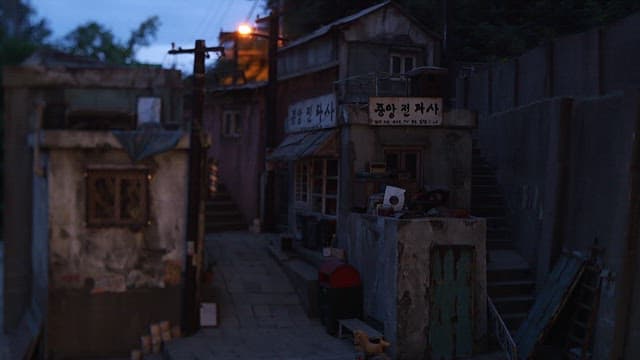 Diorama of old alleyway buildings lit up at night
