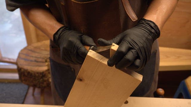 Craftsman carving wood with precision