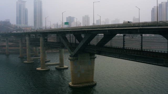 Bridge over a River on a Cloudy Day with Snow Frost