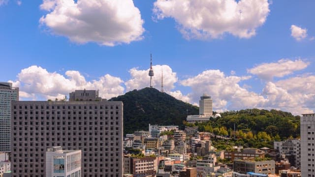 Cityscape with a prominent tower and vibrant sky