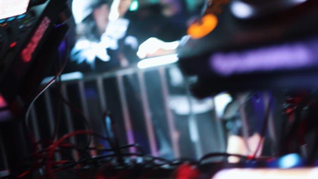 DJ's Hands Moving on the Mixing Deck