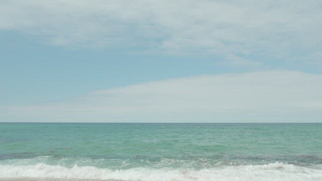 Serene Beach Scene with Calm Waters and Sky