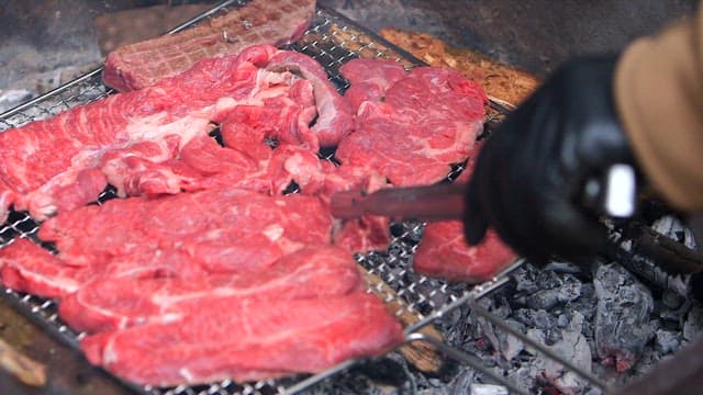 Grilling Fresh Meat on an Outdoor Barbecue