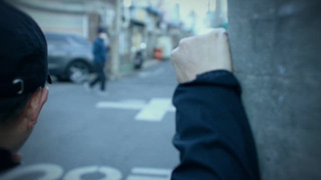 Suspicious Man Watching a Child Riding a Bicycle