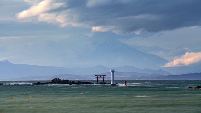 Lighthouse and clouds on the sea
