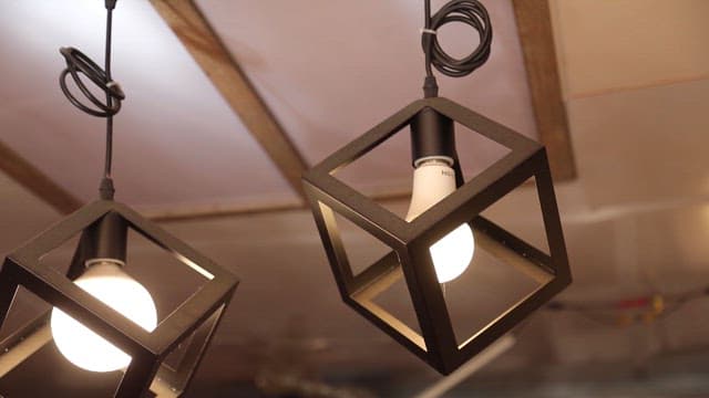 Modern cube pendant lights hanging indoors.