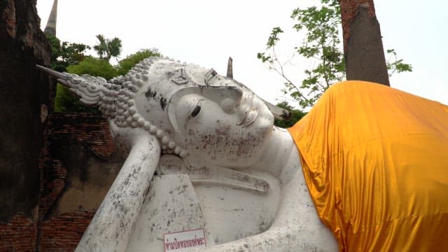 Reclining Buddha statue in ancient temple during the day