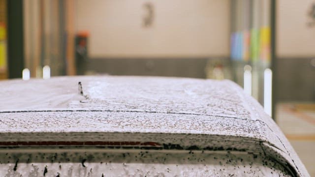 Soapy Water Sprayed on Car Roof at Car Wash