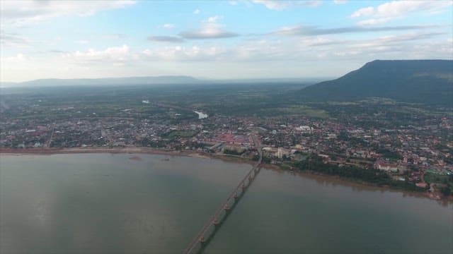 Town by the river with a distant mountain