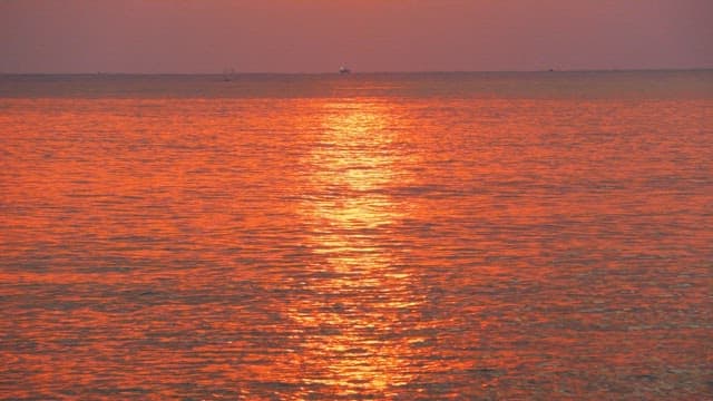 Red sunset coloring the calm and peaceful sea