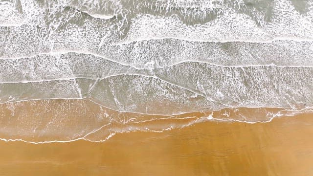 Waves gently lapping on a sandy beach