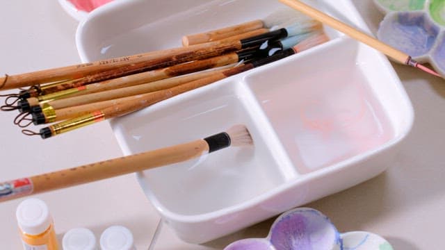 Paintbrushes and Palette on the Desk