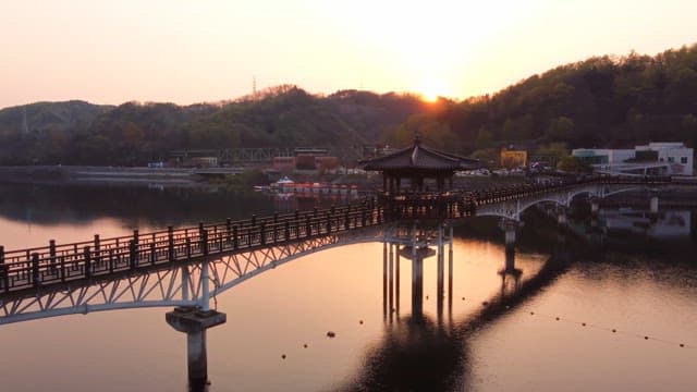 Scenic bridge over a calm river at sunset