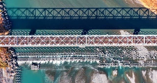 Train crossing a bridge over a river