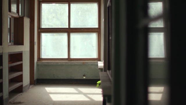 Sunlight Filtering Through an Old Window of Closed School