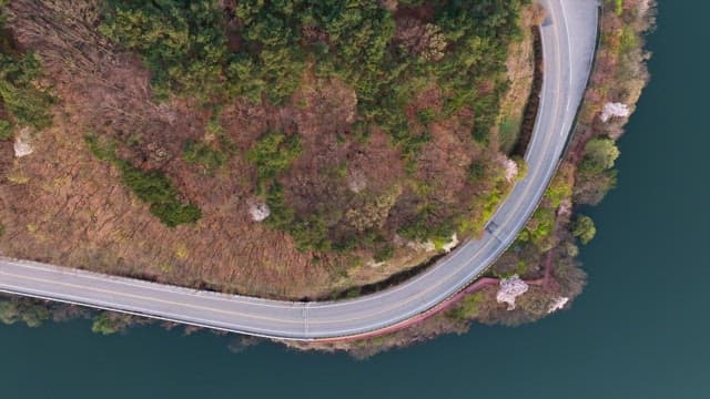 Winding road by a serene lake