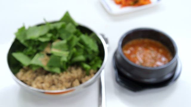 Young summer radish kimchi bibimbap and soybean paste stew on the table