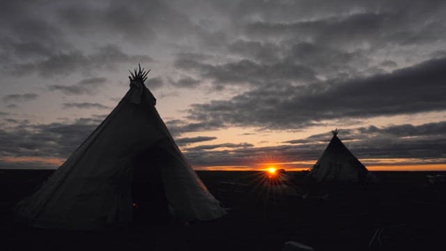 Sunset at a Remote Campsite with Tents
