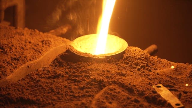 Molten metal being poured into a mold
