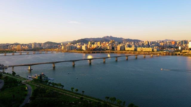 A Scenic Cityscape Alongside the River at Dusk