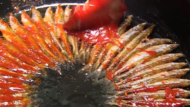 Glazed deep-fried minnows with seasoning and sprinkled with sesame