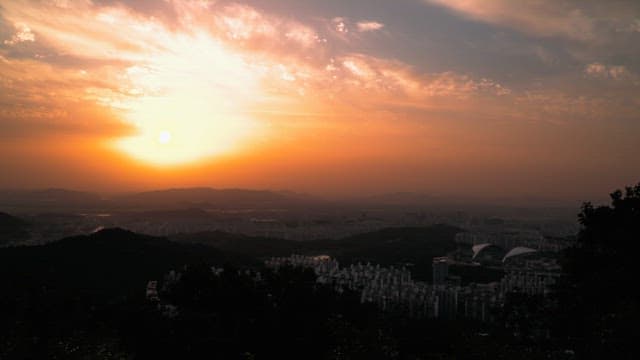 Beautiful sunset over a cityscape viewed from a mountain.