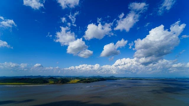Clouds Flowing over an Open Blue River
