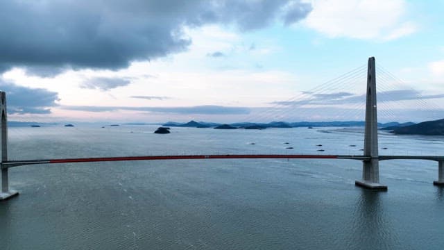 Long bridge over a calm sea with islands