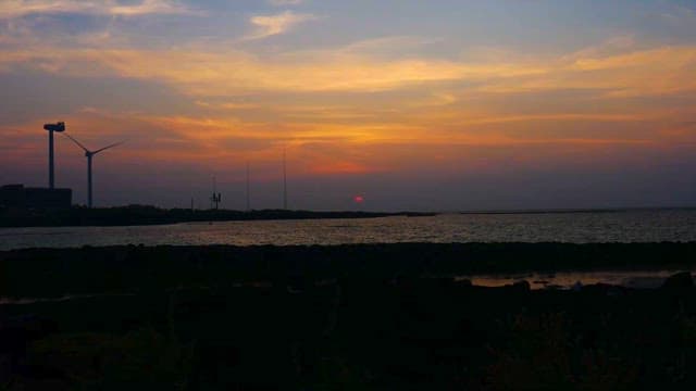 Sunset Over Coast and Wind Turbines