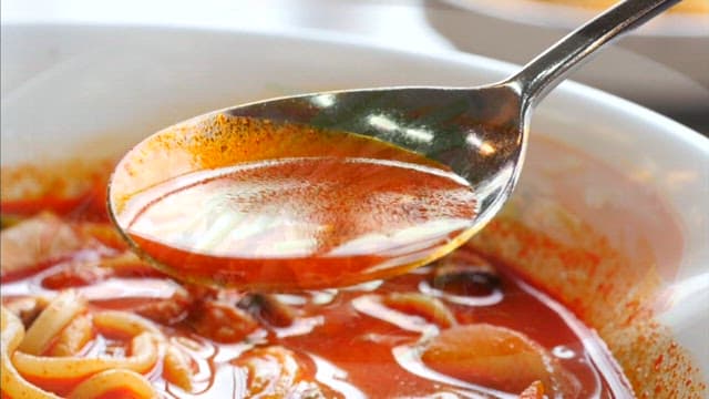 Spoonful of the delicious red soup of Jjamppong