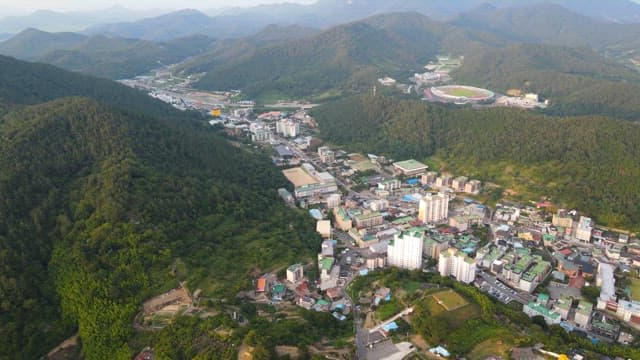 City surrounded by lush green mountains