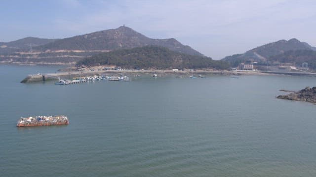 Coastal view with mountains and a pier