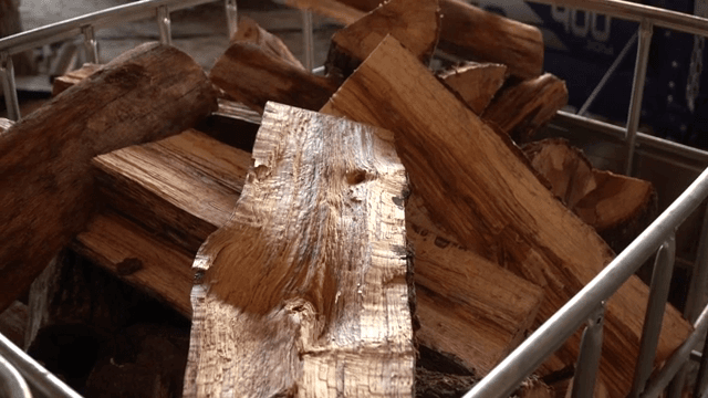 Stack of cut wooden logs in a factory