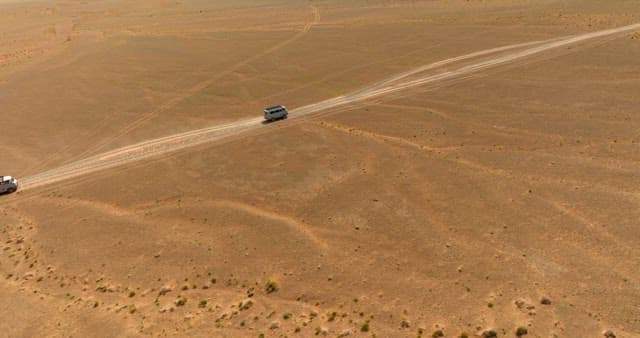 Vehicles driving on a desert road