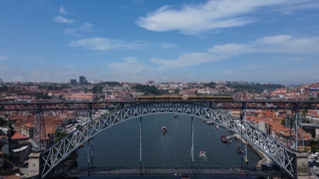 Scenery of the Riverside City Beyond the Train Crossing the Bridge