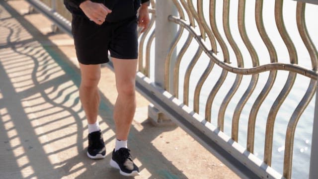 Person jogging on a bridge